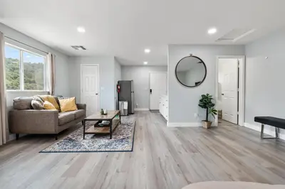 a living room with a couch and a mirror at Amazing Views Hot Tub-Games-Fire pit 6BR Sleeps 20 in Oakhurst
