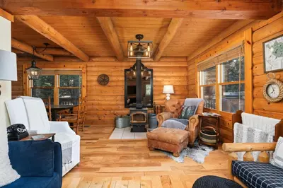 a living room with wooden walls and wooden floors at Happy Trails-Family Style Log Home Winter Escape in Shaver Lake