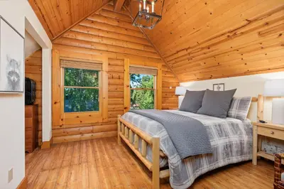 a bedroom with a bed in a log cabin at Happy Trails-Family Style Log Home Winter Escape in Shaver Lake