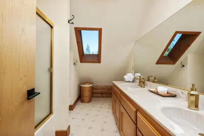 a bathroom with a sink and a mirror at Happy Trails-Family Style Log Home Winter Escape in Shaver Lake
