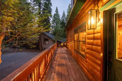 a wooden walkway leading to a porch of a house at Happy Trails-Family Style Log Home Winter Escape in Shaver Lake