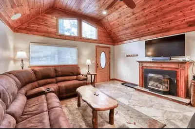 a living room with a couch and a fireplace at Villager in the Heart of Shaver Family Friendly in Shaver Lake