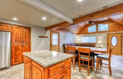 a kitchen and dining room with a table and chairs at Villager in the Heart of Shaver Family Friendly in Shaver Lake