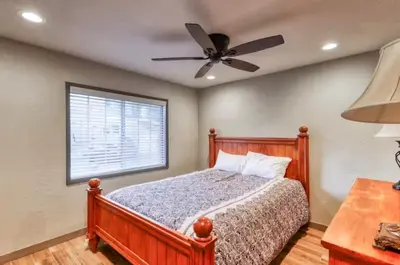 a bedroom with a bed and a ceiling fan at Villager in the Heart of Shaver Family Friendly in Shaver Lake