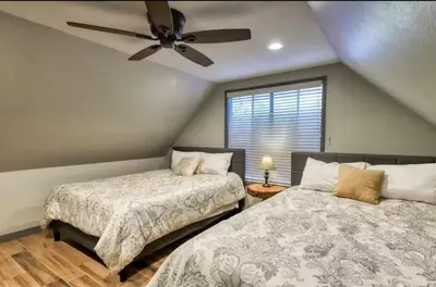 a bedroom with two beds and a ceiling fan at Villager in the Heart of Shaver Family Friendly in Shaver Lake