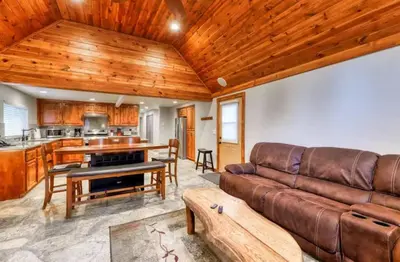 a living room with a couch and a kitchen at Villager in the Heart of Shaver Family Friendly in Shaver Lake
