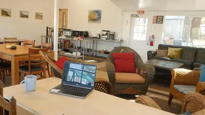 a living room with a table with a laptop on it at Cedar Springs Retreats in North Fork
