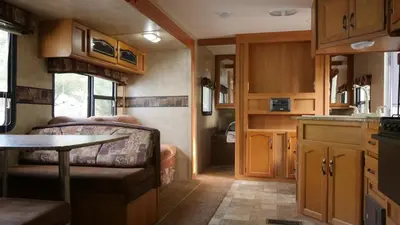 a kitchen with a couch and a table in a trailer at Cedar Springs Retreats in North Fork