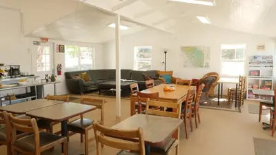 a living room with tables and chairs and a couch at Cedar Springs Retreats in North Fork