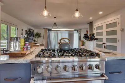 a kitchen with a stove with a tea kettle on it at Marbella Lane - Eccentric 4BR Modern Ranch Home in Reno
