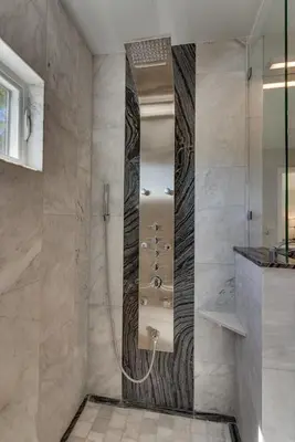 a bathroom with a shower with a sink and a mirror at Marbella Lane - Eccentric 4BR Modern Ranch Home in Reno