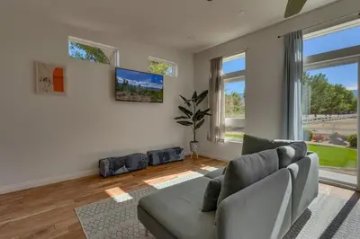 a living room with a couch and a large window at Marbella Lane - Eccentric 4BR Modern Ranch Home in Reno