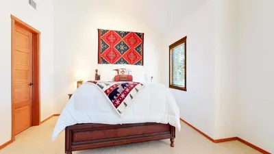 a bedroom with a white bed and a picture on the wall at Snowcreek V #819 condo in Mammoth Lakes