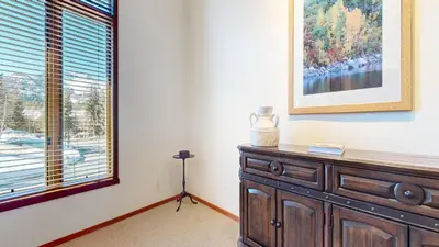 a room with a wooden dresser and a window at Snowcreek V #819 condo in Mammoth Lakes