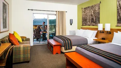 a hotel room with two beds and a couch at Rush Creek Lodge at Yosemite in Groveland