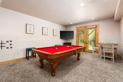 a room with a pool table and a tv at Sierra Pines- Family friendly Game Room & Fire Pit in Shaver Lake
