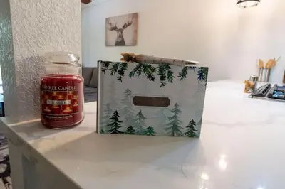 a jar of honey next to a gift bag and a jar of jam at Wilderness Hideaway-Across from the pool & spa in Shaver Lake