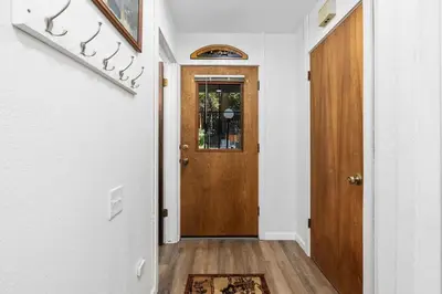 a hallway with a wooden door in a house at Wilderness Hideaway-Across from the pool & spa in Shaver Lake