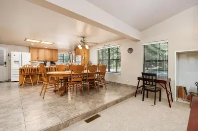 a dining room and kitchen with a table and chairs at Rustic Pines- Family Fun Game Cabin in East Village in Shaver Lake