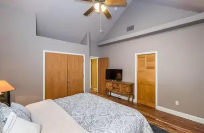 a bedroom with a bed and a ceiling fan at Handels Pride- Family friendly Game Room & Views in Shaver Lake