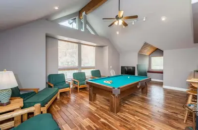 a room with a pool table and green chairs at Handels Pride- Family friendly Game Room & Views in Shaver Lake