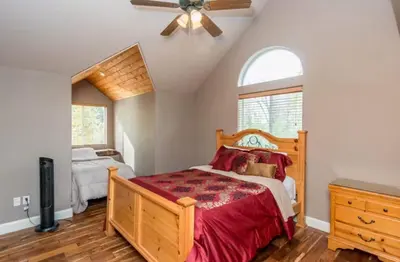 a bedroom with a bed and a ceiling fan at Handels Pride- Family friendly Game Room & Views in Shaver Lake