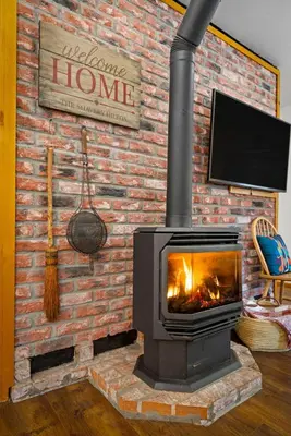 a brick wall with a fireplace in a living room at Nana & Papas-Family Friendly in East Village in Shaver Lake