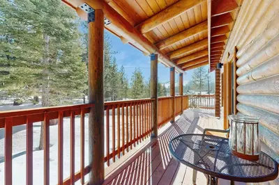 a balcony of a cabin with a table on it at Adventure Ridge Cabin in Truckee