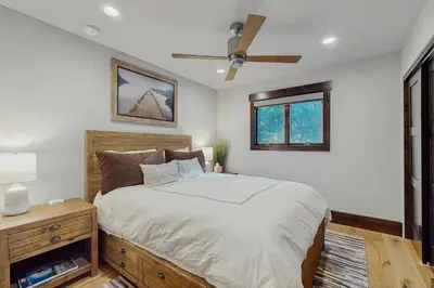 a bedroom with a bed and a ceiling fan at Lakeshore Luxe in Incline Village