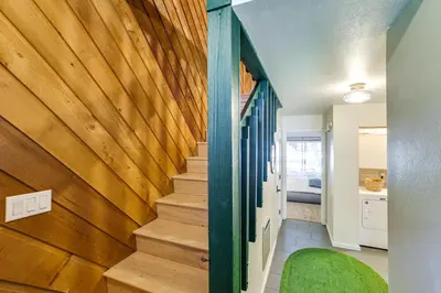 a staircase in a house with a wooden wall at 2 Mi to Eagle Lodge! Multi-Level Haven with Hot Tub in Mammoth Lakes