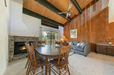 a dining room with a table and a fireplace at Kingswood Pines in Kings Beach