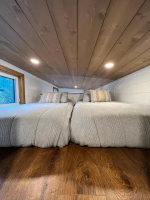 a large bed in a room with a wooden ceiling at Tiny Rustic at Yosemite Gateway in Groveland