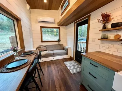 a kitchen and living room of a tiny house at Tiny Rustic at Yosemite Gateway in Groveland
