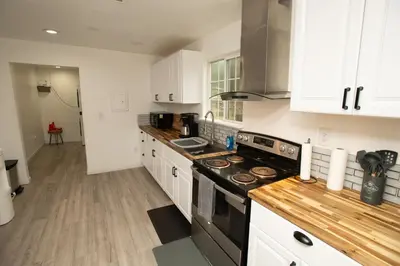 a kitchen with white cabinets and a stove top oven at Yosemite Gateway home in Groveland in Groveland
