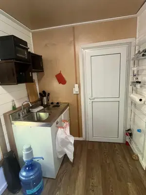 a small kitchen with a sink and a door at Tiny one house at Yosemite Gateway in Groveland