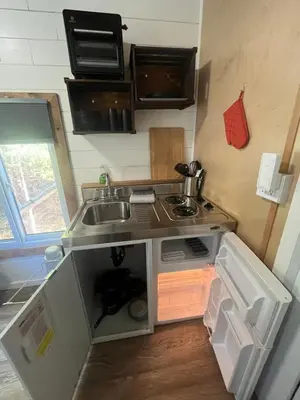 a small kitchen with a sink and a stove at Tiny one house at Yosemite Gateway in Groveland