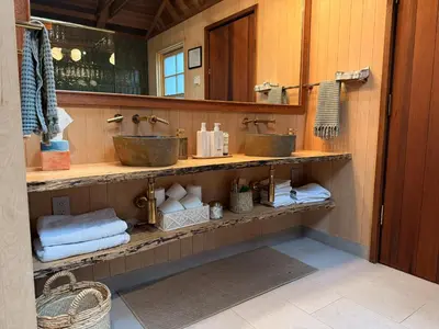 a bathroom with two sinks and towels at 45R Camp Duke in North Wawona