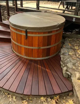 a wooden barrel sitting on top of a deck at 45R Camp Duke in North Wawona