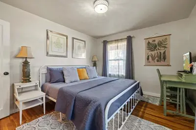 a bedroom with a bed and a desk at Vintage Vine House in Murphys