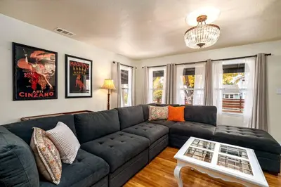 a living room with a couch and a table at Vintage Vine House in Murphys