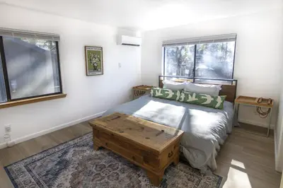 a bedroom with a bed and two windows at Boat Dock - Lake Front - Dog Friendly - Sleeps 7 in Bass Lake