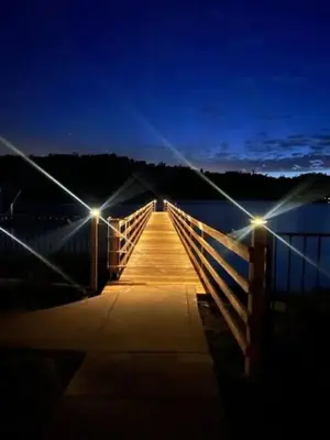a bridge over a body of water at night at Boat Dock - Lake Front - Dog Friendly - Sleeps 7 in Bass Lake