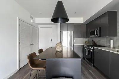 a kitchen with a table and a black counter top at Landing Modern 1BD Clubhouse Courtyard in Reno