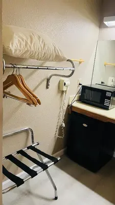 a hospital bed with a microwave on a desk at Rodeway Inn Jackson in Jackson