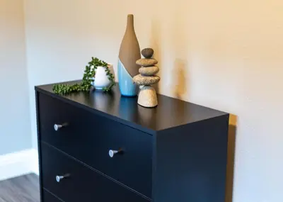 a black dresser with some items on top of it at New Modern 3bed in North Merced 5 Star hosts in Merced