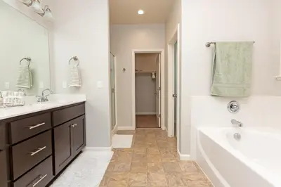 a bathroom with a tub and a sink and a tub at New Modern 3bed in North Merced 5 Star hosts in Merced