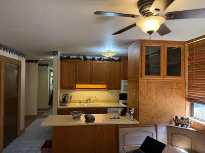 a kitchen with wooden cabinets and a ceiling fan at Northstar Studio near village and slopes in Truckee