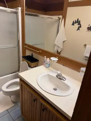 a bathroom with a sink and a toilet and a mirror at Northstar Studio near village and slopes in Truckee