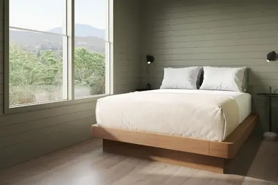 a bedroom with a large bed with a window at Outbound Yosemite in Oakhurst