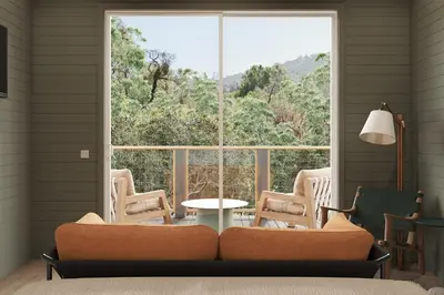 a living room with a large window and a couch at Outbound Yosemite in Oakhurst